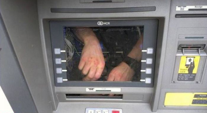 Melanie Hoff's banner, photo of hands inside bank ATM window