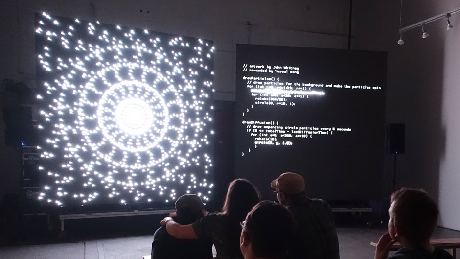 Large art display of generative art, with code beside it