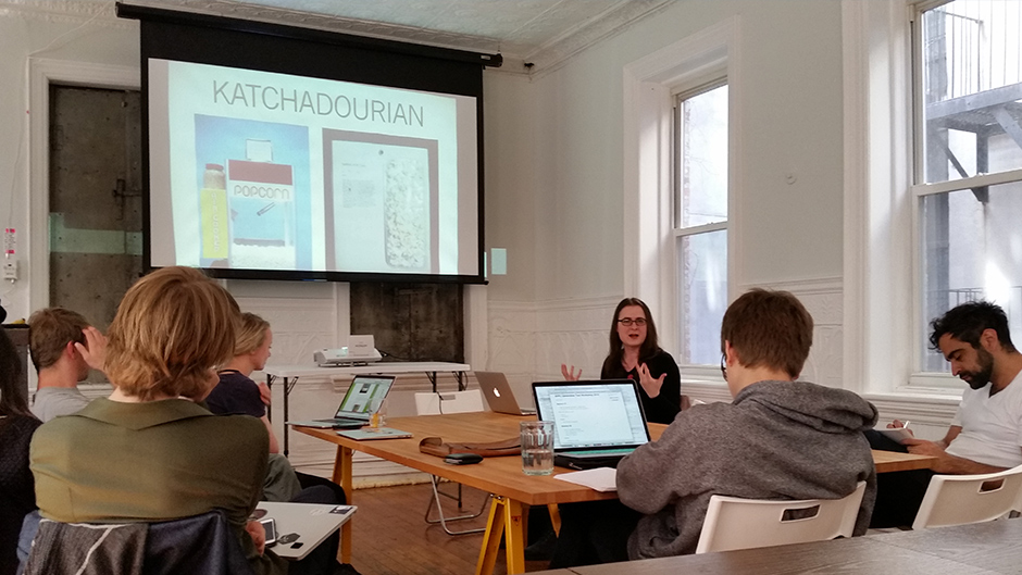 Allison Parrish presenting in front of a projector to students 