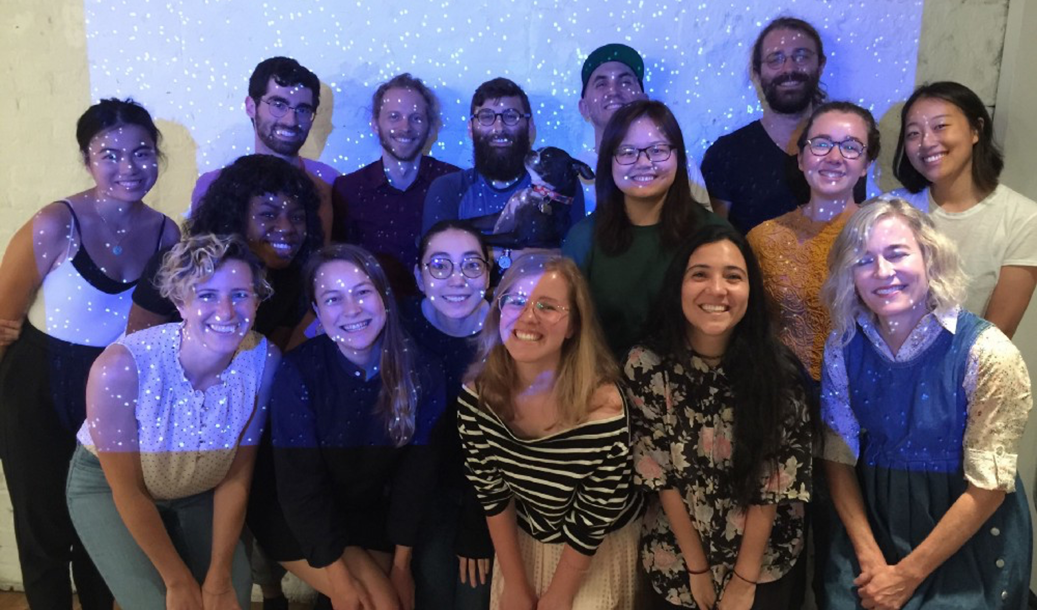 a group sfpc creative coding bootcamp photo, with projected stars on top