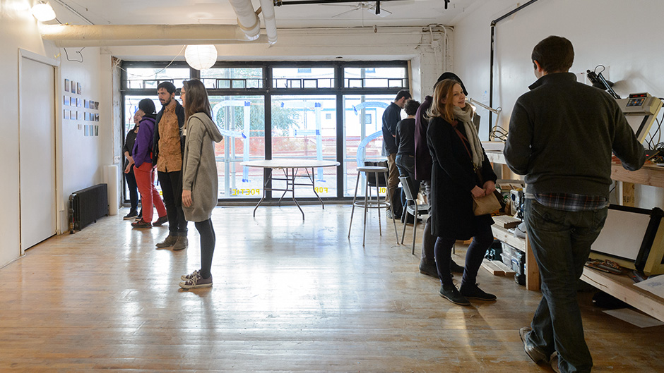 sfpc space facing the courtyard, people are talking and looking at artworks