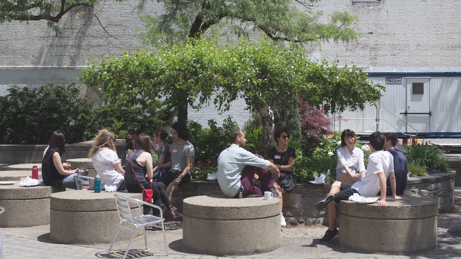SFPC students eating lunch and chatting in the courtyard by SFPC