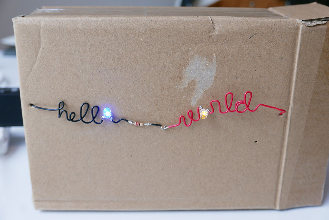 student projects, box with wire and led spelling out hello world